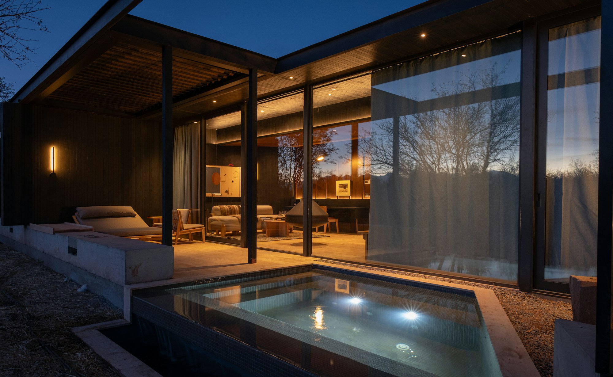Contemporary glass-and-timber architecture illuminated at dusk